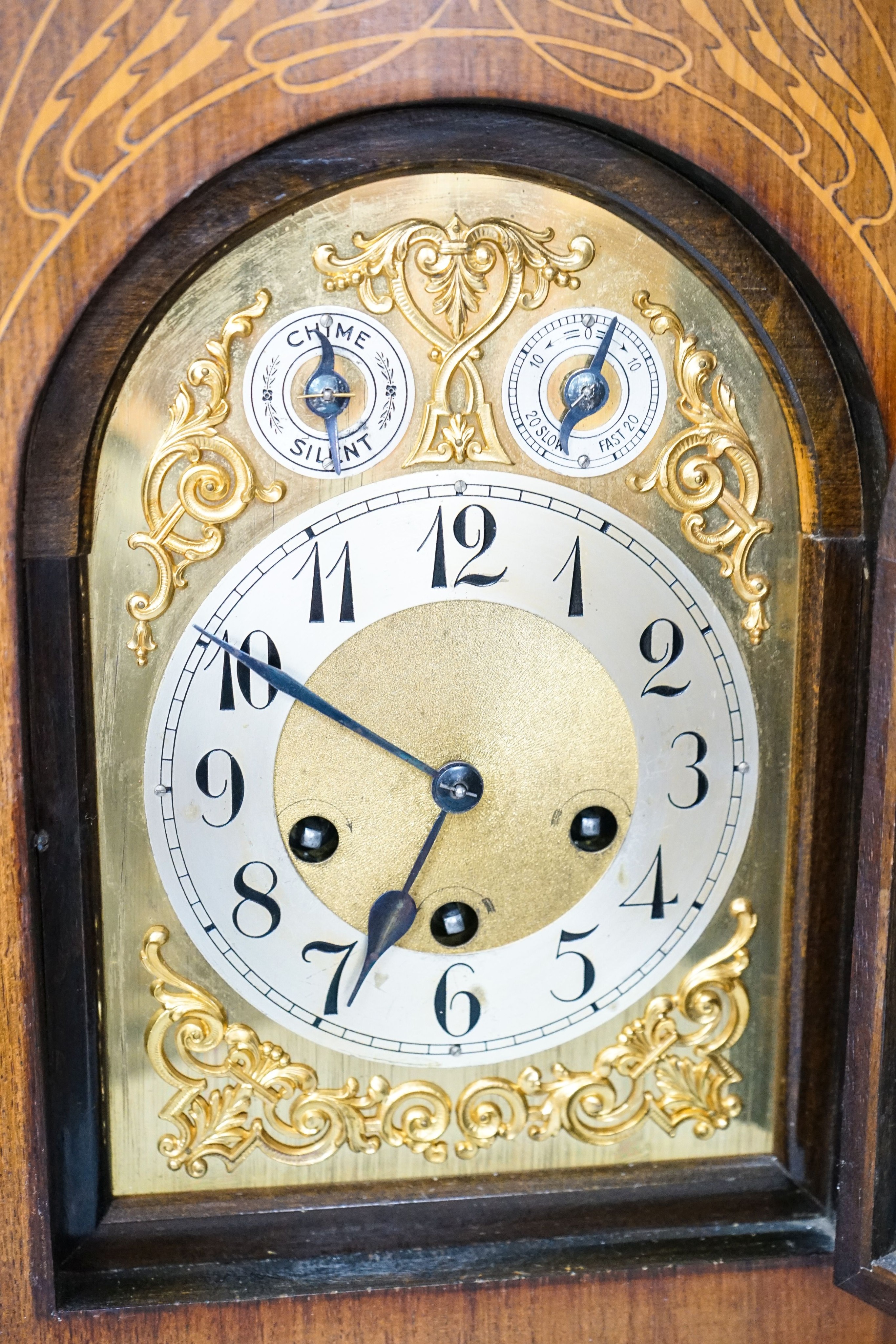 A German rosewood and marquetry chiming mantel clock, early 20th century, 45cm